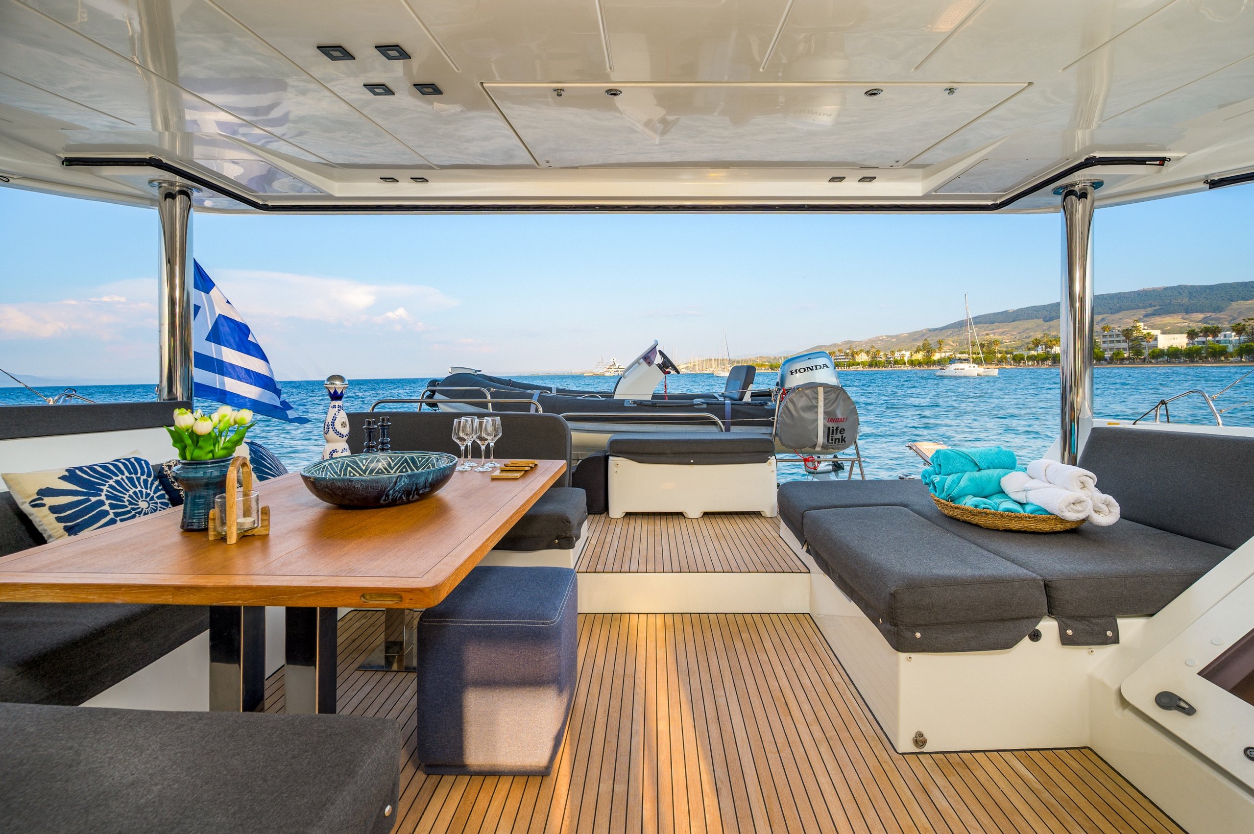 Lagoon 52F cockpit aft view tender greek flag – Stay Salty Sailing, private crewed catamaran charter Lagoon 52F cockpit aft view tender greek flag – Stay Salty Sailing, private crewed catamaran charter
